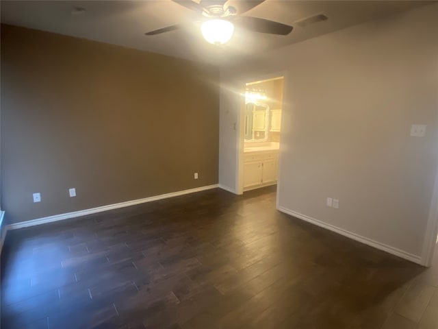 empty room with ceiling fan and dark hardwood / wood-style flooring