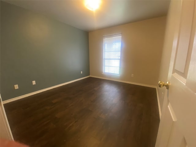 unfurnished room featuring dark hardwood / wood-style flooring