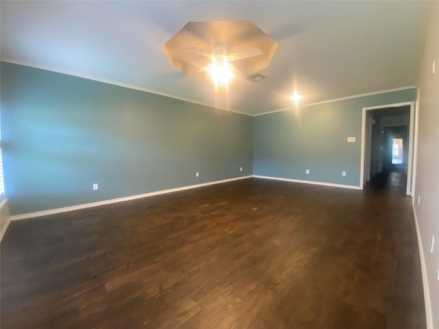 spare room with ceiling fan, dark hardwood / wood-style floors, and crown molding