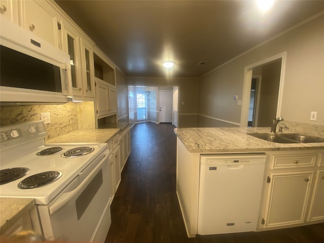 kitchen featuring sink, white appliances, and white cabinetry