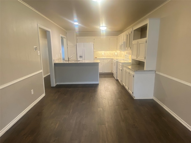 kitchen with white cabinets, backsplash, white appliances, sink, and dark wood-type flooring