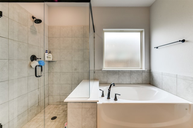 bathroom with separate shower and tub