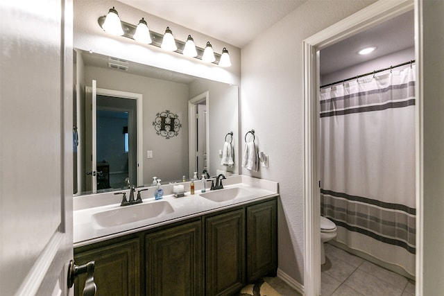 bathroom with a shower with curtain, tile patterned flooring, toilet, and vanity