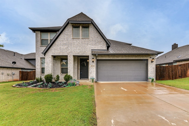 view of front of property featuring a garage and a front yard