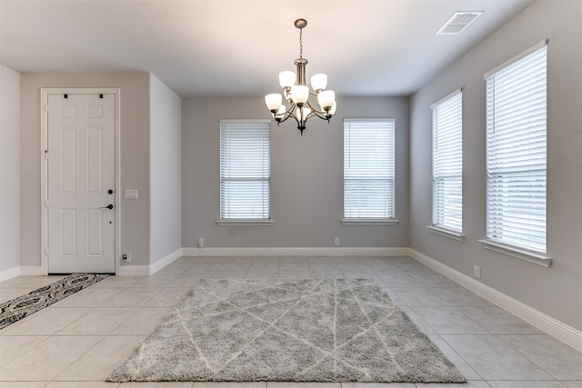 interior space with a notable chandelier and light tile patterned floors