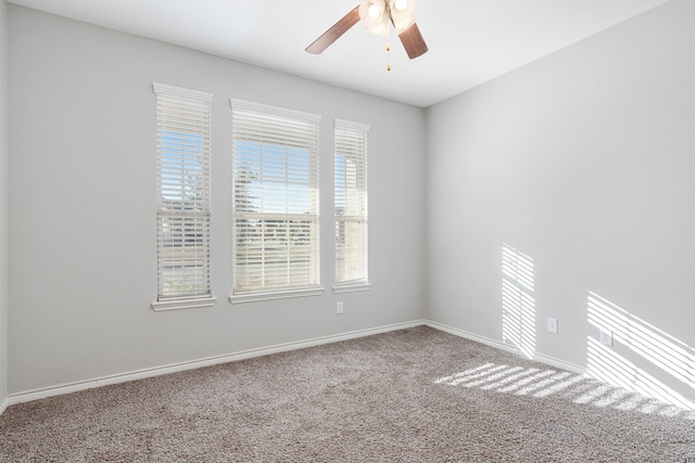 carpeted empty room featuring ceiling fan