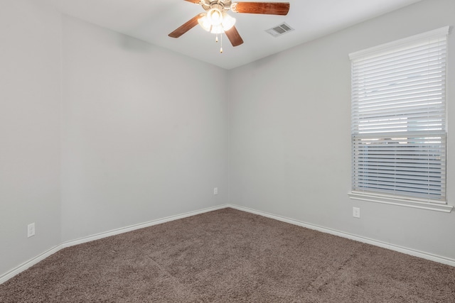 empty room with ceiling fan and carpet flooring