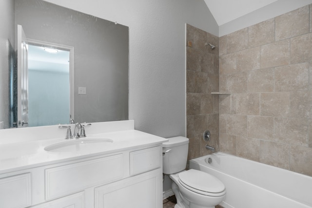 full bathroom with vaulted ceiling, vanity, tiled shower / bath combo, and toilet