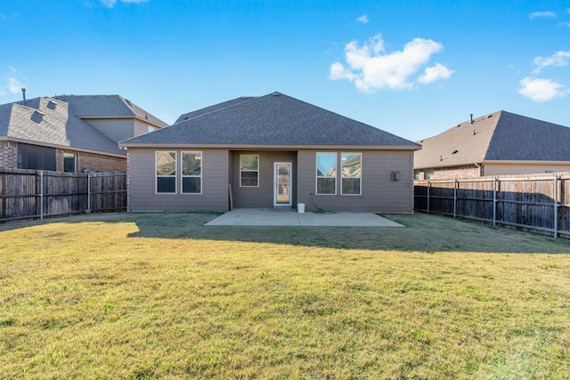 back of house with a yard and a patio area