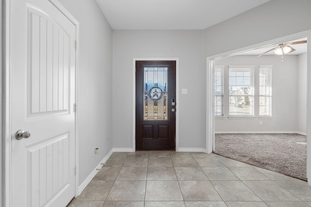 foyer featuring light colored carpet and ceiling fan