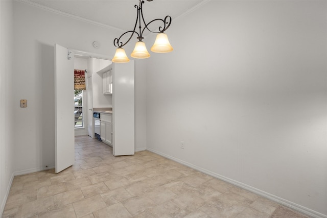 unfurnished dining area featuring crown molding and an inviting chandelier