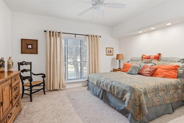 bedroom with ceiling fan and light carpet