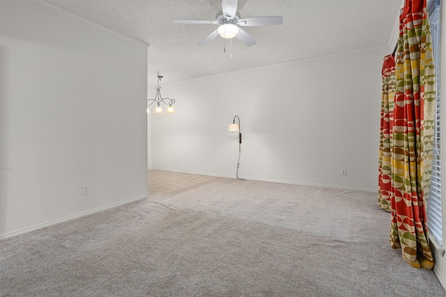 carpeted spare room featuring a textured ceiling and ceiling fan with notable chandelier