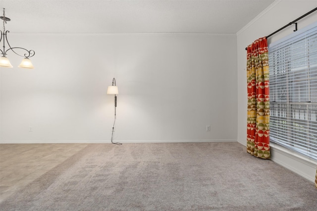 carpeted empty room featuring ornamental molding