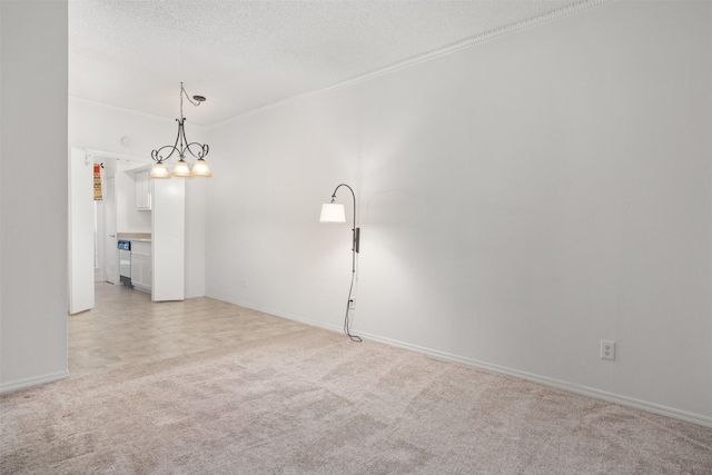 unfurnished room featuring light carpet, a textured ceiling, and an inviting chandelier