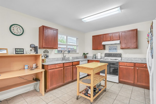 kitchen featuring light tile patterned floors, white appliances, light stone counters, and sink