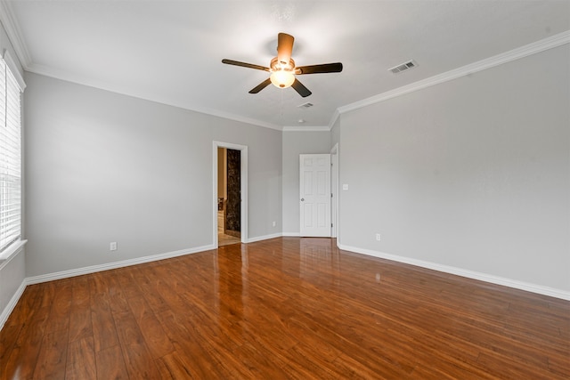 unfurnished room with ornamental molding, dark wood-type flooring, ceiling fan, and a healthy amount of sunlight