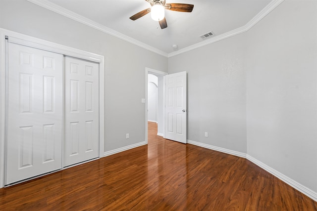 unfurnished bedroom featuring ornamental molding, a closet, ceiling fan, and hardwood / wood-style flooring