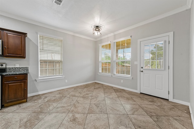 unfurnished dining area featuring light tile patterned floors and crown molding