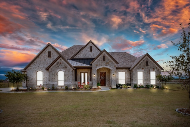 french country home with a yard