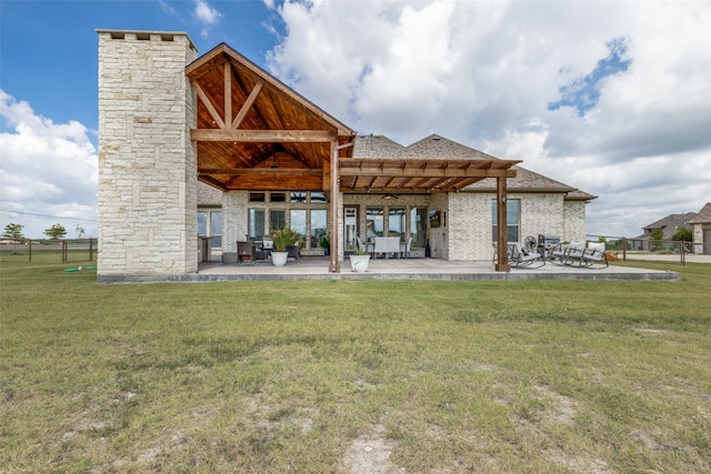 back of property featuring a yard and a patio