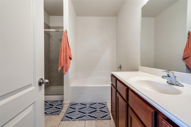 full bath with vanity, tile patterned floors, a garden tub, and a stall shower