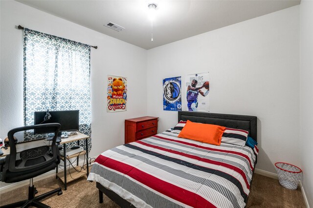 bedroom with dark colored carpet