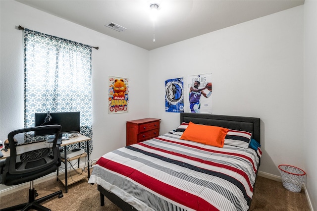 carpeted bedroom featuring baseboards and visible vents