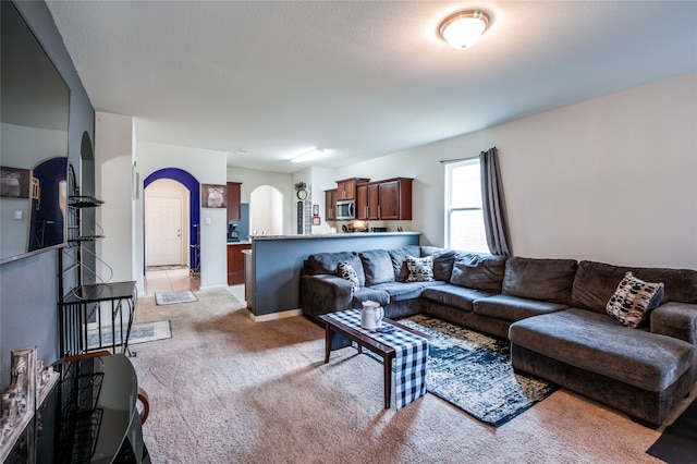 carpeted living room with a textured ceiling