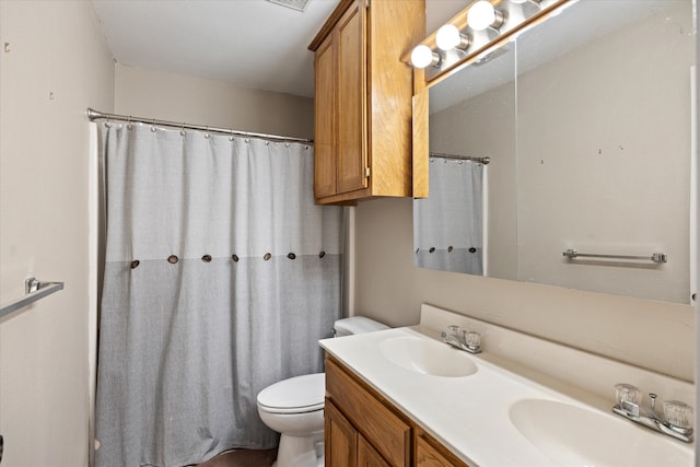 bathroom featuring vanity, toilet, and a shower with shower curtain