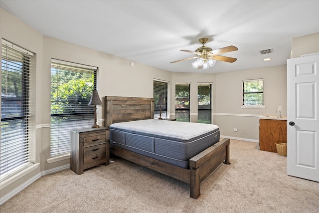 bedroom with ceiling fan and light colored carpet