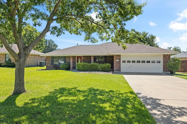 single story home featuring a front lawn, a garage, and central AC unit