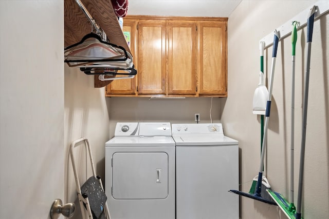 laundry area with cabinets and washer and clothes dryer