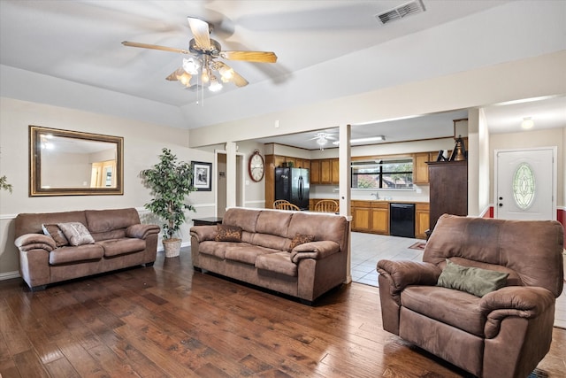 living room with ceiling fan, sink, and wood-type flooring