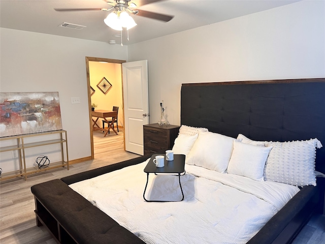 bedroom with ceiling fan and hardwood / wood-style flooring