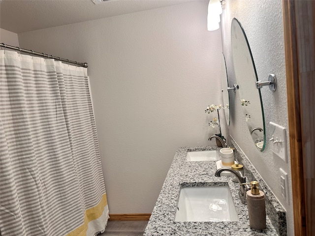 bathroom featuring a shower with curtain and vanity