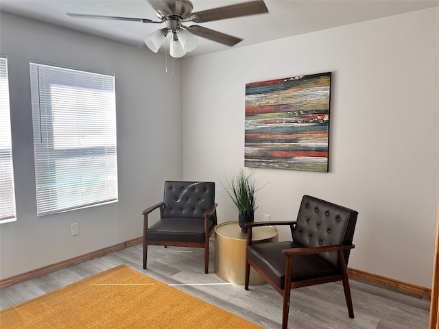 living area featuring ceiling fan and light hardwood / wood-style flooring