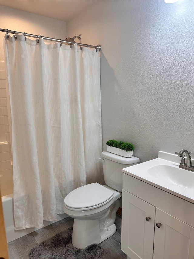 full bathroom featuring vanity, toilet, shower / bath combo, and hardwood / wood-style flooring