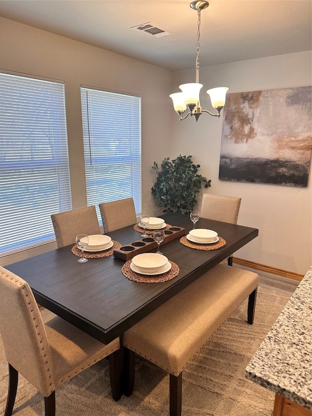 dining area featuring an inviting chandelier