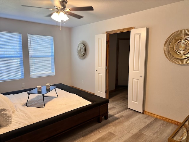 bedroom with ceiling fan and light hardwood / wood-style flooring