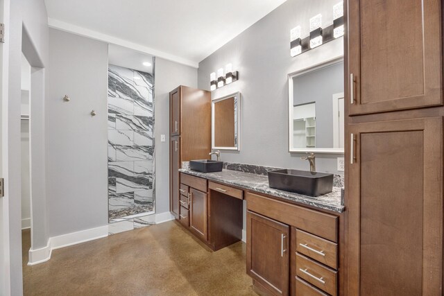 bathroom with vanity and a tile shower