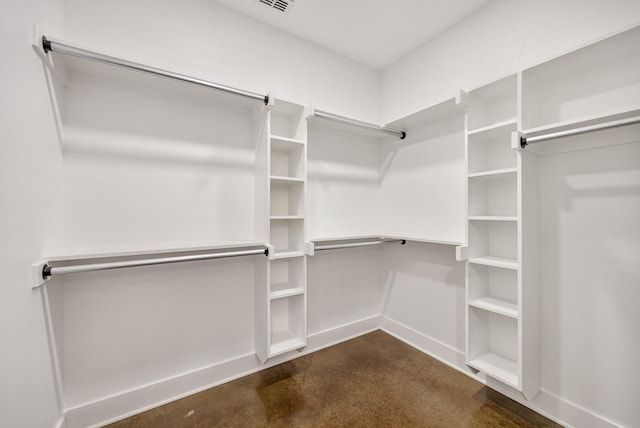 walk in closet featuring dark carpet