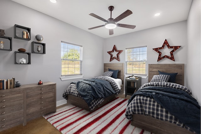 bedroom featuring carpet floors, multiple windows, and ceiling fan