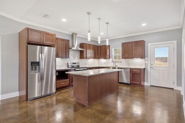 kitchen with appliances with stainless steel finishes, ornamental molding, wall chimney range hood, decorative light fixtures, and a kitchen island