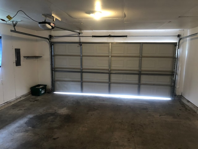 garage featuring electric panel and a garage door opener