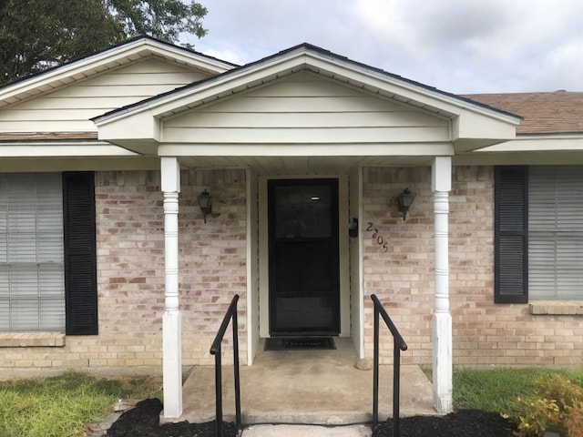 view of exterior entry featuring a porch