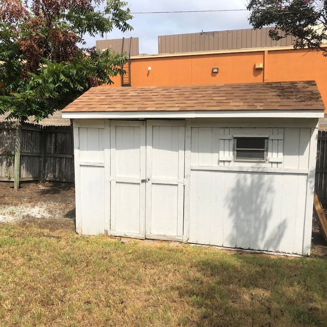 view of outbuilding with a lawn