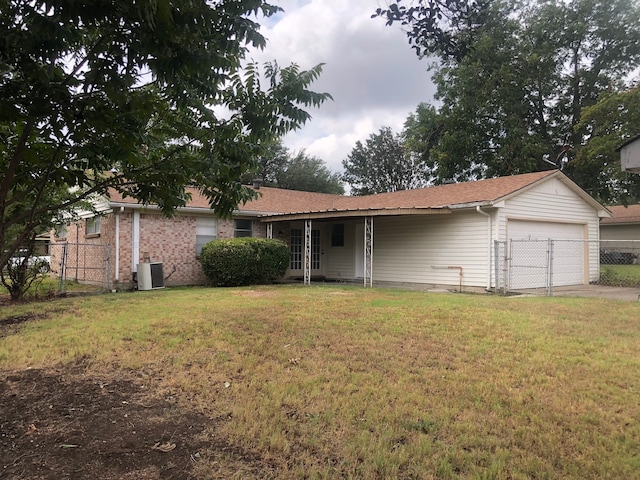 ranch-style home featuring central air condition unit, a garage, and a front lawn