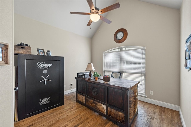 office space featuring high vaulted ceiling, wood finished floors, a ceiling fan, and baseboards