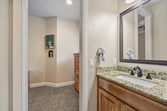 bathroom with vanity and baseboards